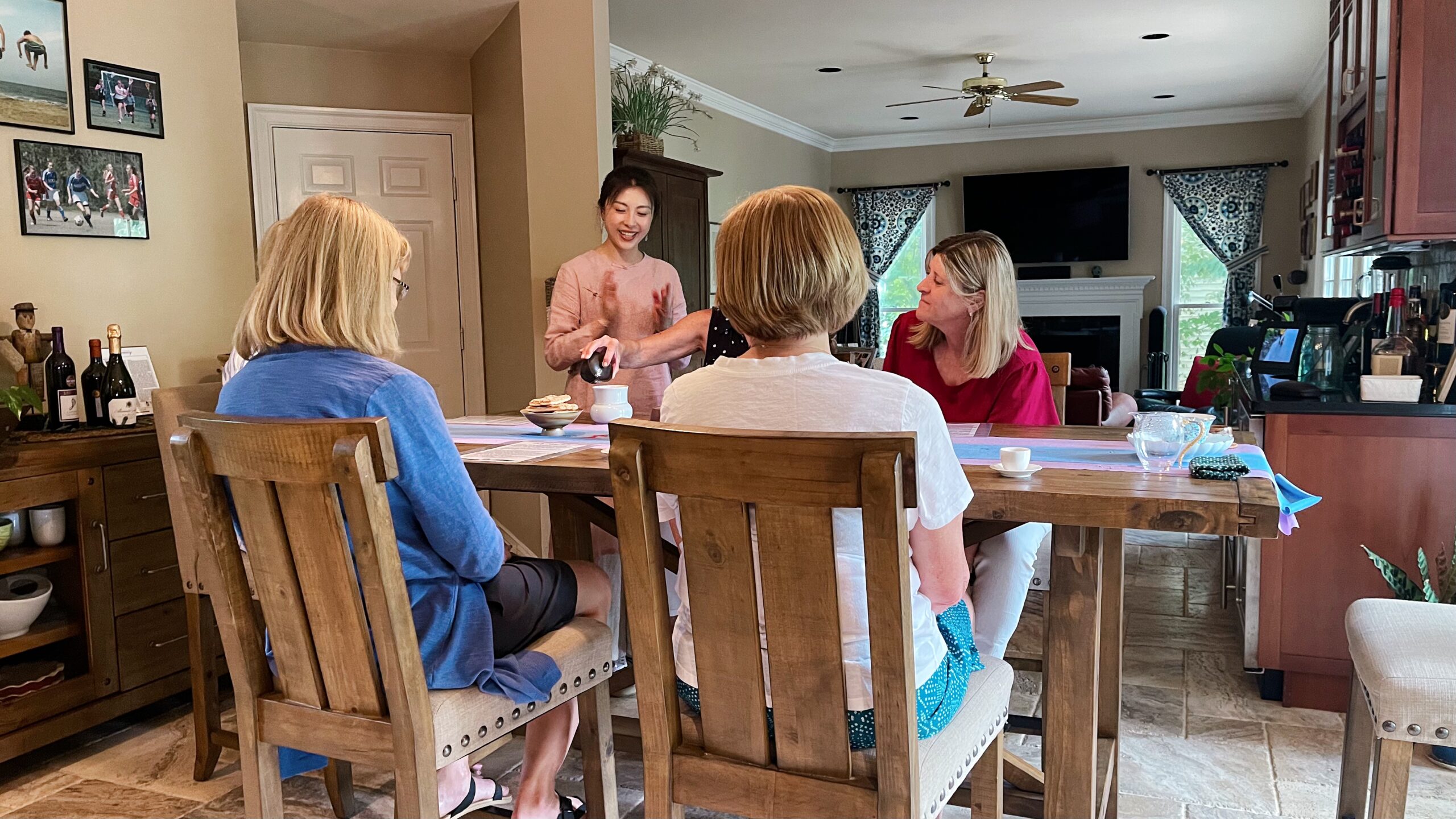 Feather Chen hosting a small-group tea gathering with guests