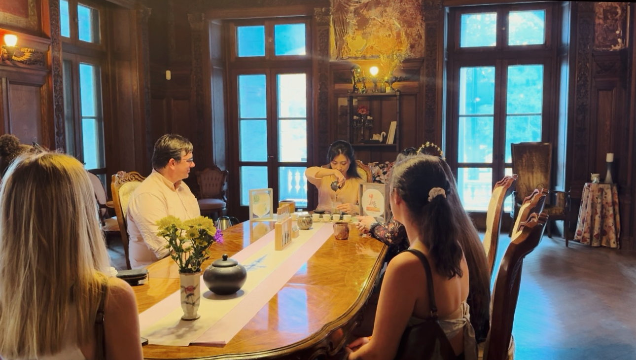 Guests enjoying a Chinese tea gathering inside the historic house during the SUN/SETS