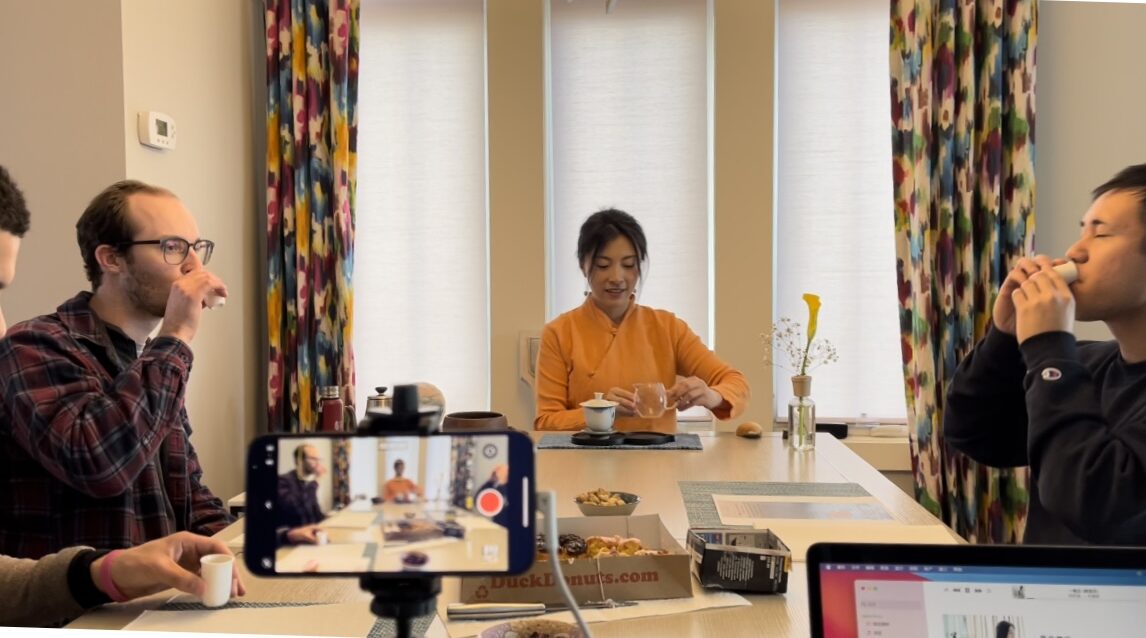 Feather Chen hosting a private Chinese tea tasing in a home setting.